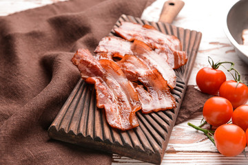 Fried bacon on wooden board