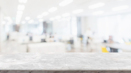 Empty white marble stone table top and blur glass window wall in office building space interior...