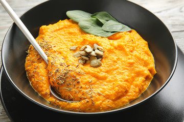 Delicious pumpkin cream soup in bowl