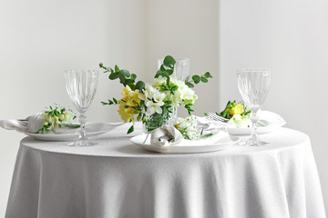 Beautiful table setting with fresh freesia flowers