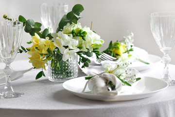 Beautiful table setting with fresh freesia flowers