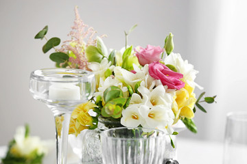 Beautiful bouquet with fresh freesia flowers on table, closeup