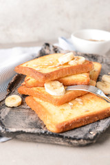 Tasty French toasts and banana on plate