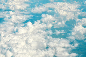 Naklejka premium White clouds and blue sky view from airplane window. - Image