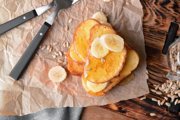 Tasty French toasts with banana on table