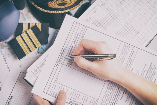 Airplane pilot filling in flight plan