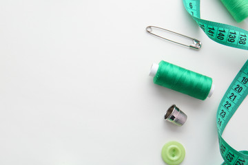 Sewing threads and accessories on white background