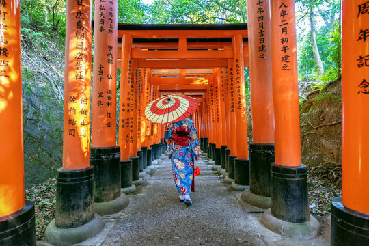 Asian women in traditional japanese kimonos at Fushimi Inari Shrine in Kyoto, Japan.