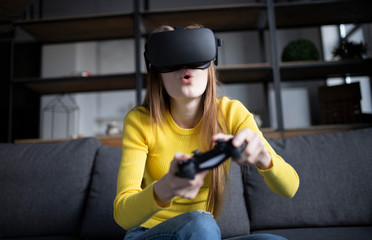 Cute girl plays the game on the console. VR experience