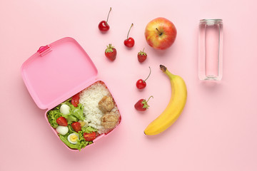School lunch box with tasty food and water on color background