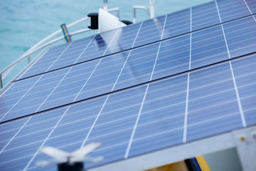 Side view of solar cells converting energy on yacht in bright day