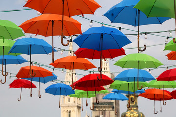 Fototapeta na wymiar Colorful umbrellas on the street of Zagreb, Croatia. Cathedral of the Assumption of the Blessed Virgin Mary in the background. Selective focus.