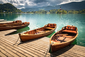 Fototapeta na wymiar scenic view on beautiful wooden flat rowing boats on lake bled, slovenia, go green concept
