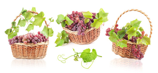 Grapes with leaves in wicker basket, Isolated on white background