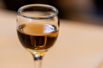 A glass with a drink on a blurred background. Soft focus. Concept. Close-up
