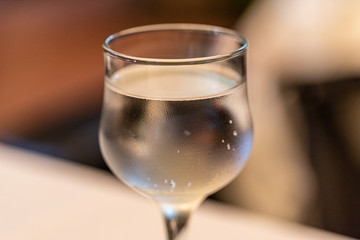 A glass with a drink on a blurred background. Soft focus. Concept. Close-up