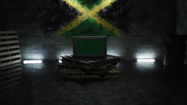Modern Green Screen TV in dark studio on wooden pallets and bright neon lights. Jamaican flag on brick wall. Reflection on wet smooth floor. Light turning on. Metal barrel. Tracking out. Mock up 4K.