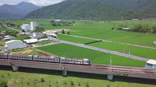 Train pass through a red steel arch bridge, Yuli, Hualien, Taiwan