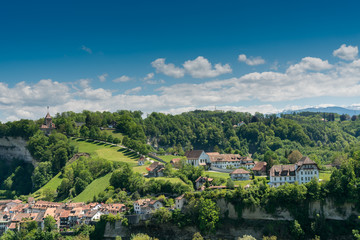 view of the historic Swiss city of Fribourg with its old town and famous chapel on the hill
