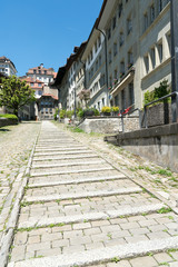Fototapeta na wymiar long stone stairs leading from the lower to the upper town in the historic old city of Fribourg in Switzerland