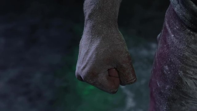 Tight fist of a floured man in a dark studio with dust or white flour on a hummy and shiny soil. Reflection of green light. Close up tilt up. 4K Slow motion.