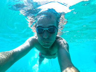 Underwater view of a diver man swimming