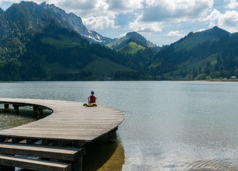 tourist enjoying a day out on the shores of Schwarzsee Lake in Fribourg