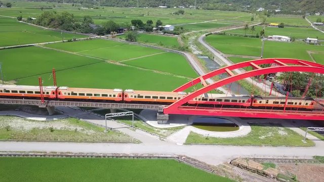 Train pass through a red steel arch bridge, Yuli, Hualien, Taiwan