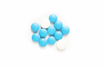 Health and medication concept blue and white pills drug or tablets on white background with copy space