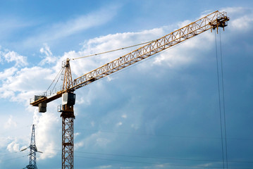 Silhouette of tower crane against the evening sky. 
