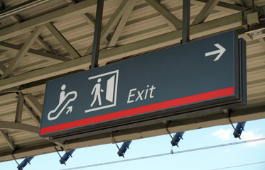 Direction sign banner arrow label way to escalator and exit.