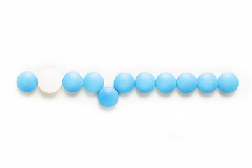 Health and medication concept blue and white pills drug or tablets on white background with copy space