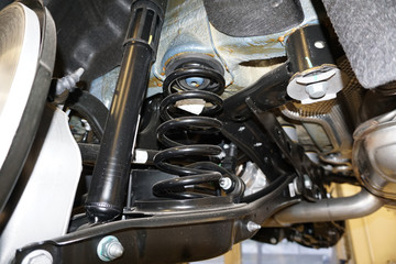 Sharp technical photograph.  The design and elements of a modern car. Rear suspension. Shock...