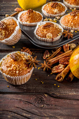 Homemade Autumn Pumpkin Spice Muffins with Pecan nuts. Fall and winter baking. Old rustic wooden background copy space.