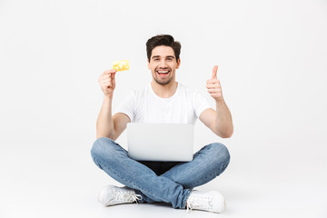 Full length portrait of a cheerful young man