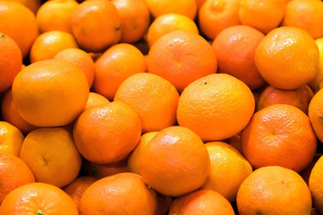 Fresh mandarin oranges for sale at fruit market. Tasty tangerine fruits are full of vitamins and minerals