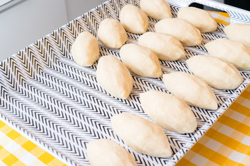 Making of Cepelinai - Zeppelins is national Lithuanian dish. Pork meet is wrapped inside of raw potatoes mash and boiled in hot water