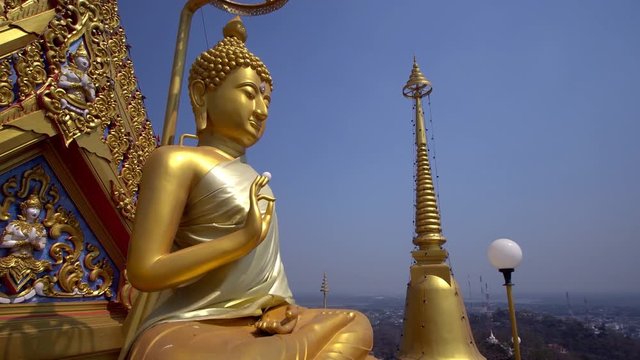 Giant Buddha statue at hilltop temple in Nakorn Sawan, Thailand.