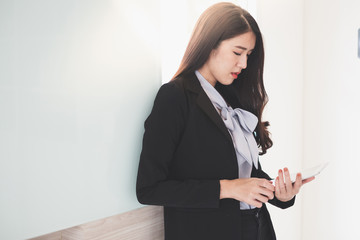 Young asian businesswoman holding tablet while she working at the office.