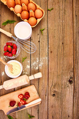 Bakery background. Recipe for strawberry pie. Raw ingredients for cooking strawberry pie or cake on rustic background. Top view, flat lay. Copy space.