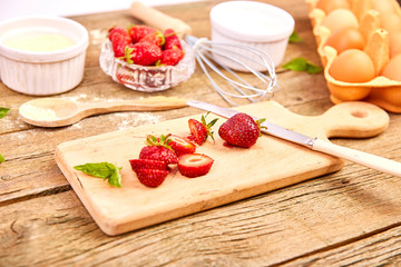 Strawberry on cutting board. Recipe for strawberry pie. Raw ingredients for cooking strawberry pie or cake on rustic background. Top view, flat lay. Copy space.