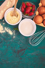 Bakery background. Recipe for strawberry pie. Raw ingredients for cooking strawberry pie or cake on green background. Top view, flat lay. Copy space.