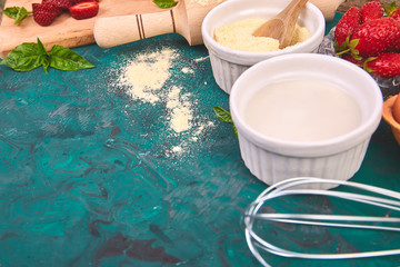 Bakery background. Recipe for strawberry pie. Raw ingredients for cooking strawberry pie or cake on green background. Top view, flat lay. Copy space.