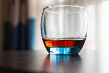 Glass of whiskey stands on a table