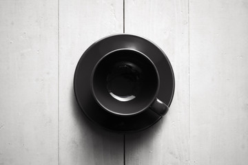 Empty black coffee cup on wooden table