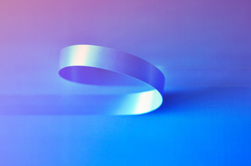 Shiny satin ribbon in blue on a blue background. Image tape for decoration design