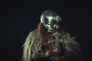 Surrender, Viking, Scandinavian warrior with helmet and war paintings, wears a sword and a cape of animal skin