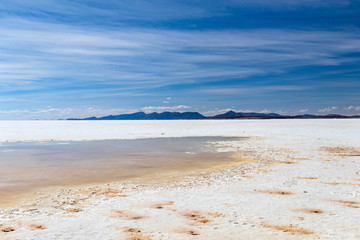 Landscape of incredibly white salt flat Salar de Uyuni, amid the Andes in southwest Bolivia, South America