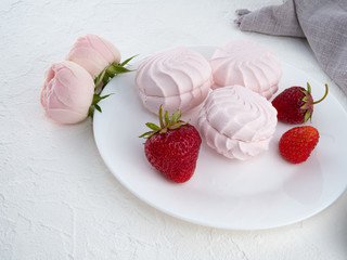 Beautiful delicious airy pink marshmallow on white background. Copy space.