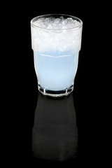 coconut water with ice cubes, concept summer cool drink, over black background